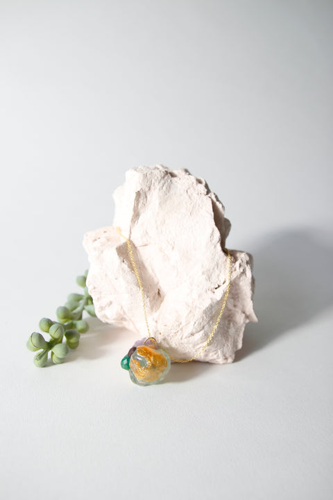 Amulet necklace in coral reef