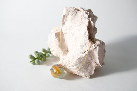 Amulet necklace in coral reef