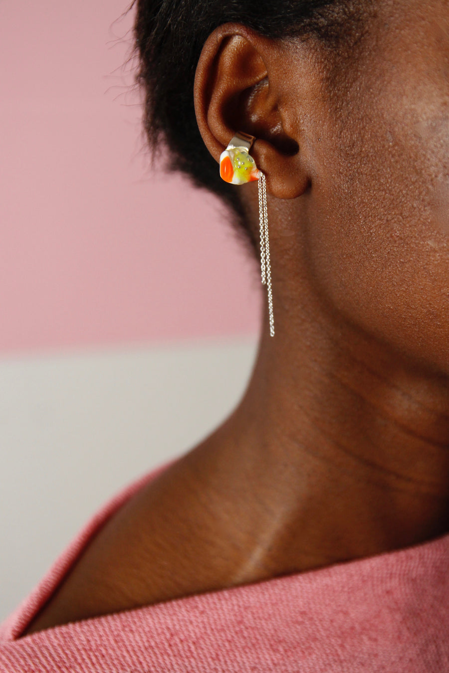 Woman wearing a unique Handcrafted Dangling Ear Cuff by Gré in citrus colours with sterling silver