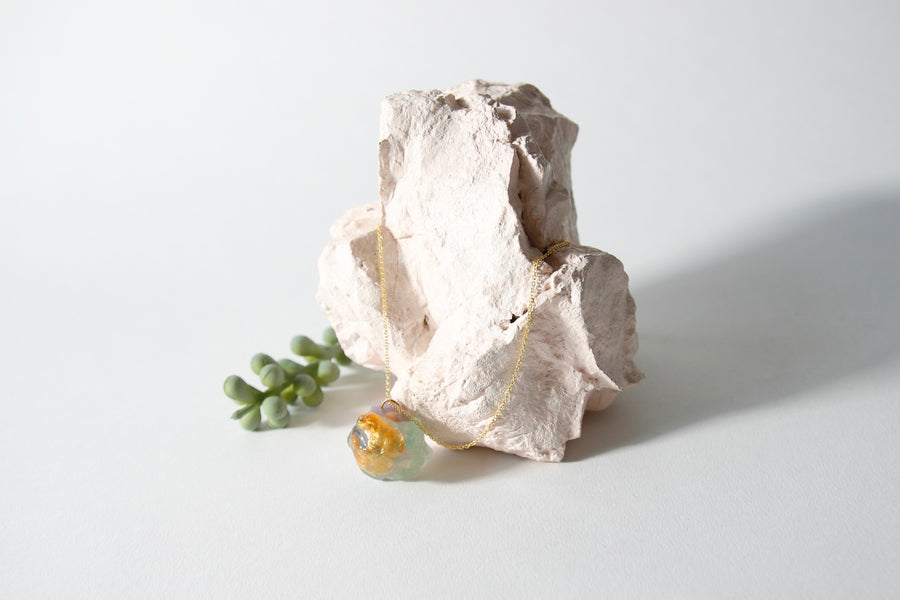 Amulet necklace in coral reef